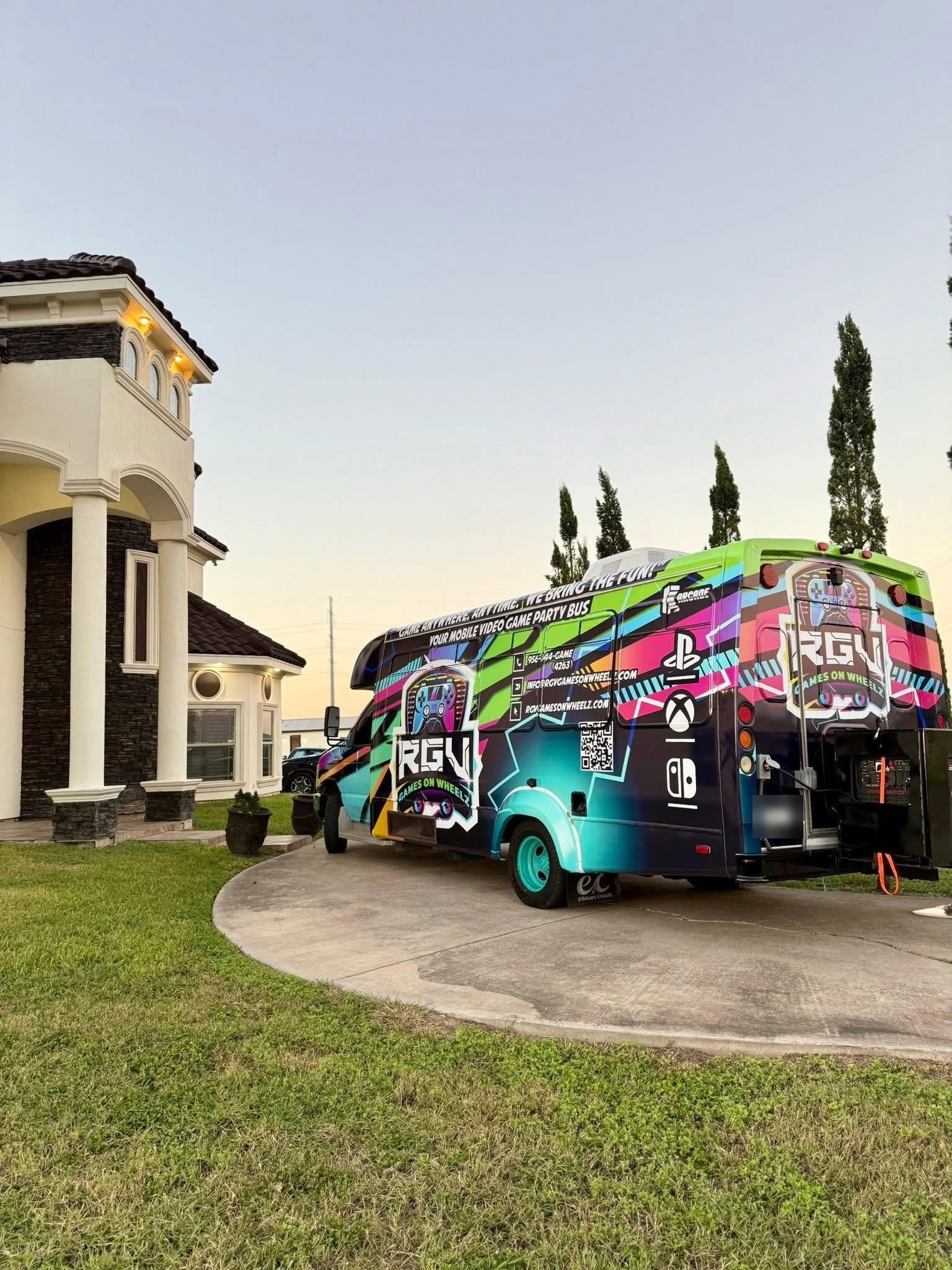 The RGV Games on Wheelz mobile gaming bus parked in a residential driveway at dusk