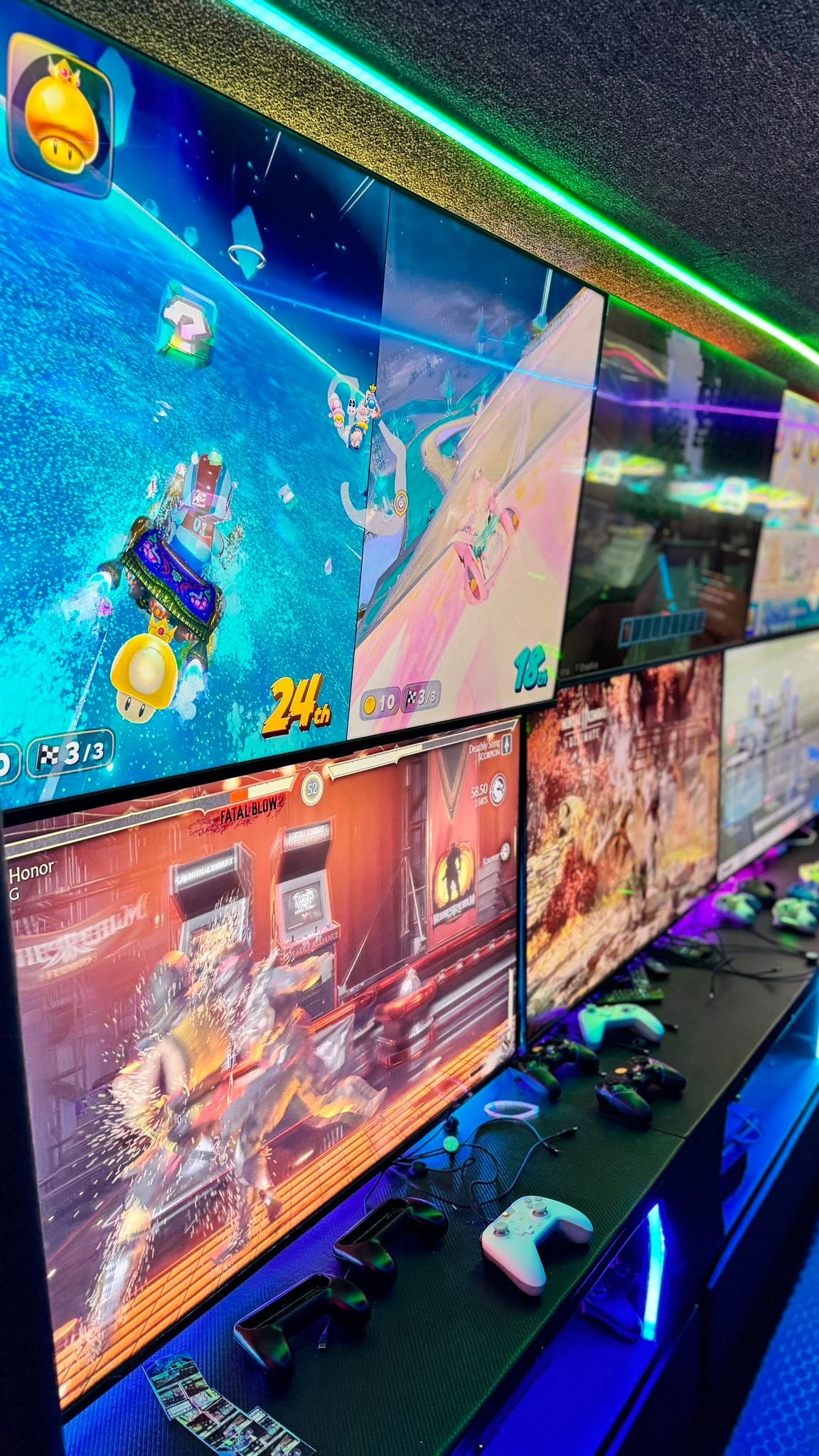 The lit screen wall and gaming stations inside the RGV Games on Wheelz mobile gaming bus