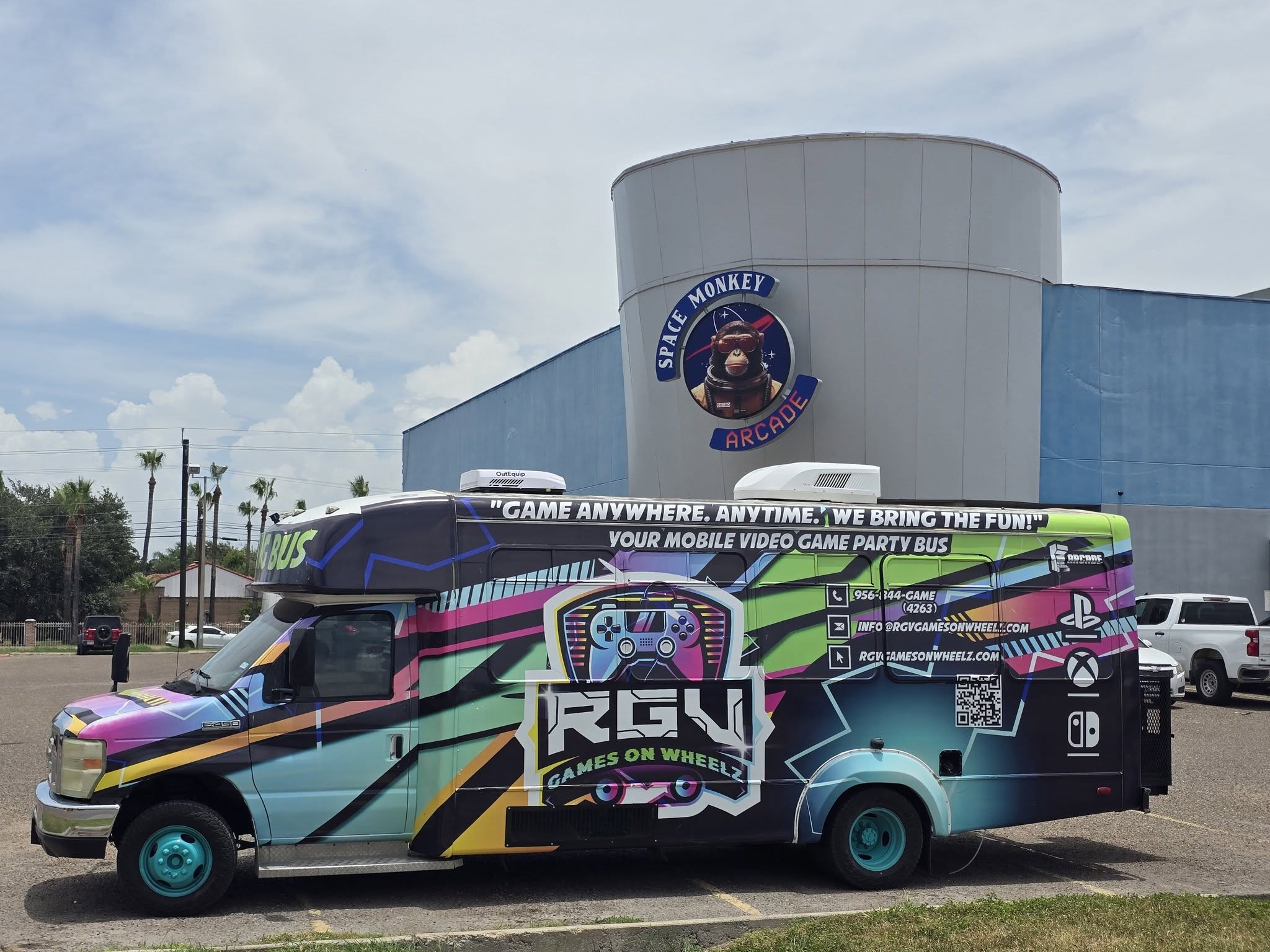 The full length of the RGV Games on Wheelz mobile gaming bus and its graphics wrap, parked outside an arcade venue